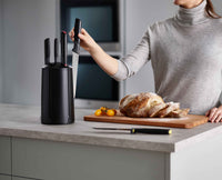 Elevate knife with weighted handle and integrated knife rest