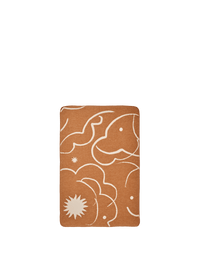 ferm LIVING Skye brushed cotton blanket in sienna and parchment, folded on a neutral background