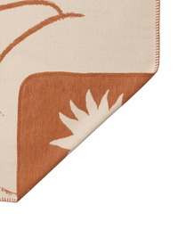 ferm LIVING Skye blanket displaying the celestial star pattern in sienna