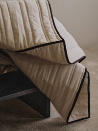ferm LIVING Vari bedspread styled on a bed showing the quilted channels