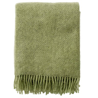 Klippan Gotland pear-green brushed wool throw, folded with fringe, on white