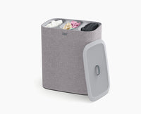 Joseph Joseph Tota Trio 90L grey laundry basket with lid, on white