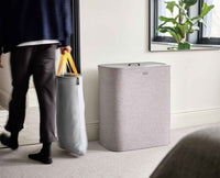 Tota Trio grey laundry basket in a home setting
