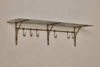 Basti iron storage shelf with six hooks shown against a pale wall