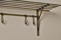 Detail of the hooks and hammered antique brass finish on the Basti shelf