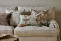 Dantri soft grey cushion styled with neutral cushions on a linen sofa