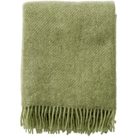 Klippan Gotland pear green wool throw shown to display its brushed surface and fringe