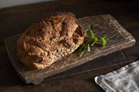 Kaveeta reclaimed wood board used to serve a loaf of bread