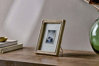 Pambani antique brass 5 x 7 photo frame styled on a shelf