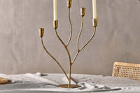 Palani statement candelabra styled with candles on a dining table