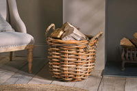 Rattan Chunky Basket filled with logs beside an armchair