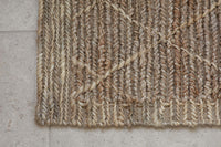 Close-up of the woven diamond pattern on the Vandi jute doormat
