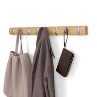 Umbra Flip 8 wall-mounted hook rail in natural wood with nickel hooks on a white background