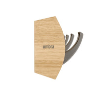 Close-up of the Umbra Flip 8 rail showing the retractable nickel hooks and natural wood