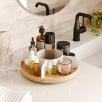 Umbra Bellwood Lazy Susan used on a bathroom vanity to hold beauty bottles