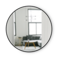 Umbra Hub round wall mirror with a black rubber frame shown alone on a plain background