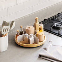 Umbra Bellwood Lazy Susan holding oils and jars in a kitchen corner