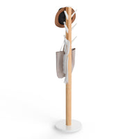 Umbra Flapper freestanding coat rack in natural wood with white hooks and white base on a white background